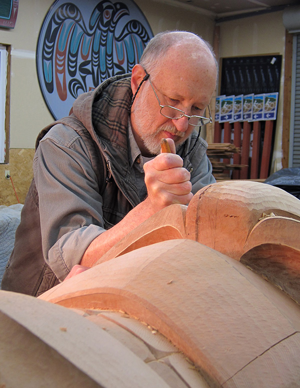 Dale Faulstich carving a totem pole.